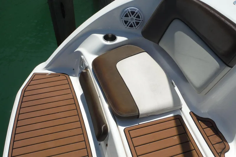 Slide: The Image of 2011 Yamaha Boats 242 Limited interior with cushioned seating and teak-style flooring. - 33