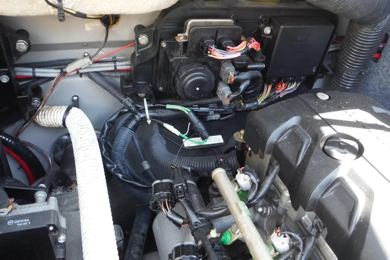 Slide: The Image of Engine compartment of a 2011 Yamaha Boats 242 Limited, showcasing wiring and components. - 29