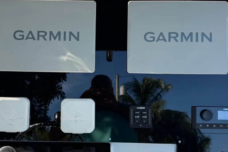 Slide: The Image of Garmin electronics on a 2001 Century 2900 Center Console boat dashboard. - 14