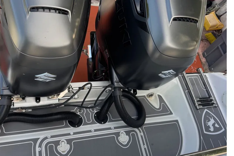 Slide: The Image of Twin Suzuki outboard motors on a 2001 Century 2900 Center Console boat. - 16