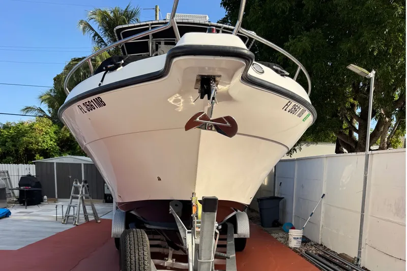 Slide: The Image of 2001 Century 2900 Center Console boat on trailer in a residential yard. - 18