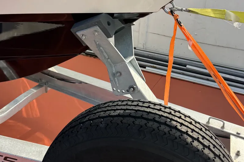 Slide: The Image of Trailer hitch and tire securing a 2001 Century 2900 Center Console boat. - 20