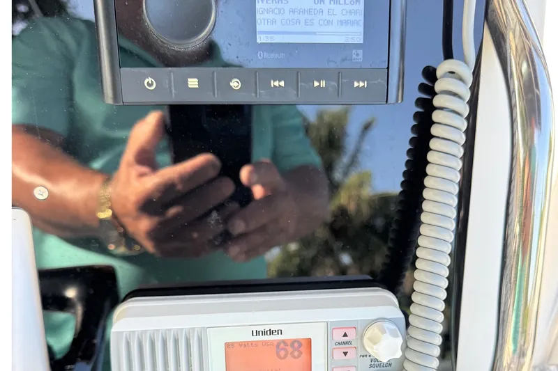 Slide: The Image of Close-up of a 2001 Century 2900 Center Console boat's control panel with radio and display. - 13