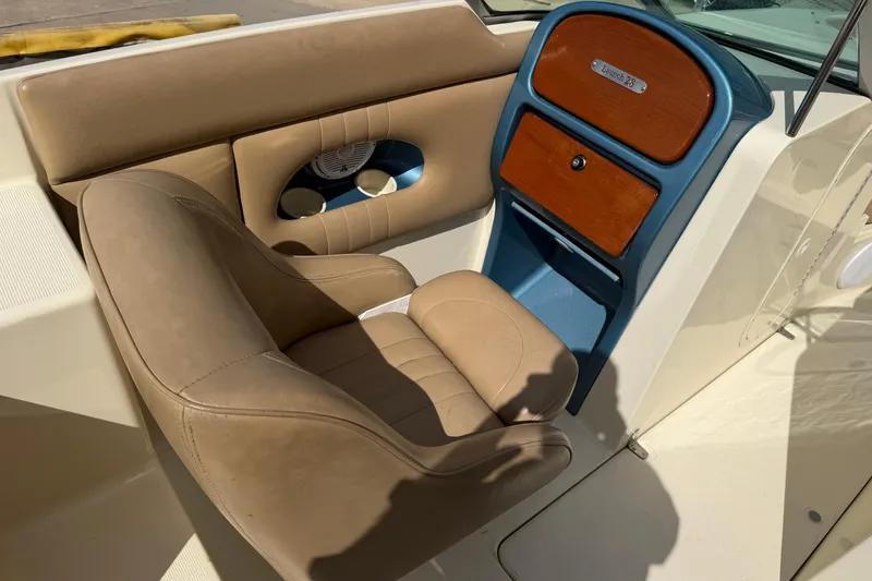 Slide: The Image of 2001 Chris-Craft Launch 28 interior with tan seating and wooden dashboard accents. - 15