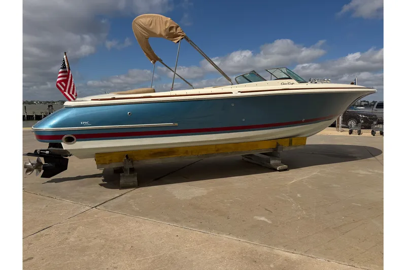 The Image of 2001 Chris-Craft Launch 28 boat on display, featuring a blue hull and American flag. - 0