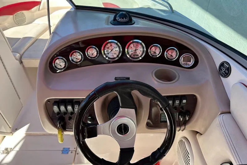 Slide: The Image of Dashboard of a 2000 Chaparral 216 SSi boat with gauges and steering wheel. - 23
