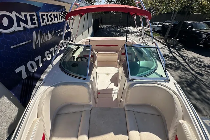 Slide: The Image of 2000 Chaparral 216 SSi boat with red canopy and open seating area. - 29