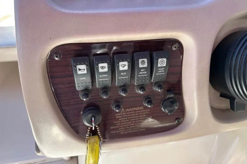 Slide: The Image of Control panel of a 2000 Chaparral 216 SSi boat with labeled switches and warning text. - 25