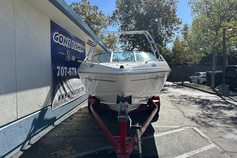 Slide: The Image of Chaparral 216 SSi 2000 boat on trailer outside Gone Fishin' Marine dealership. - 2