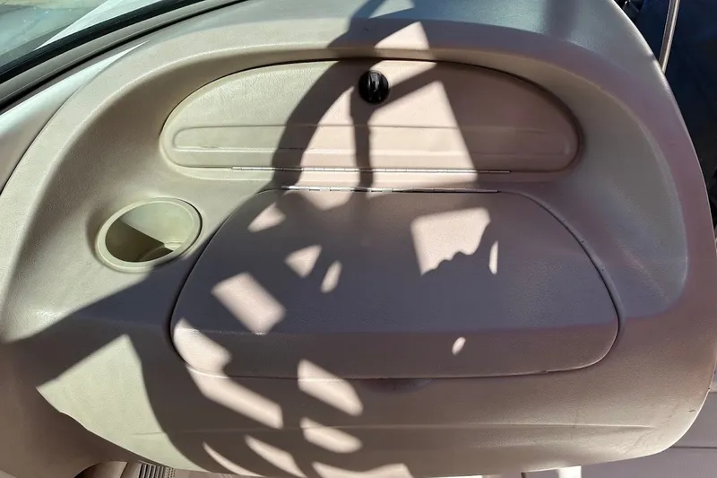 Slide: The Image of Interior door panel of a 2000 Chaparral 216 SSi boat with cup holder. - 16