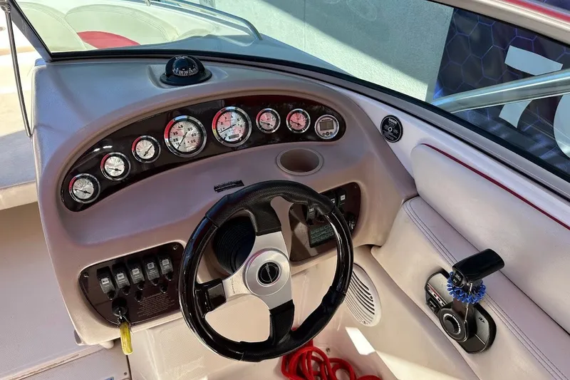 Slide: The Image of Dashboard of a 2000 Chaparral 216 SSi boat with gauges and steering wheel. - 22