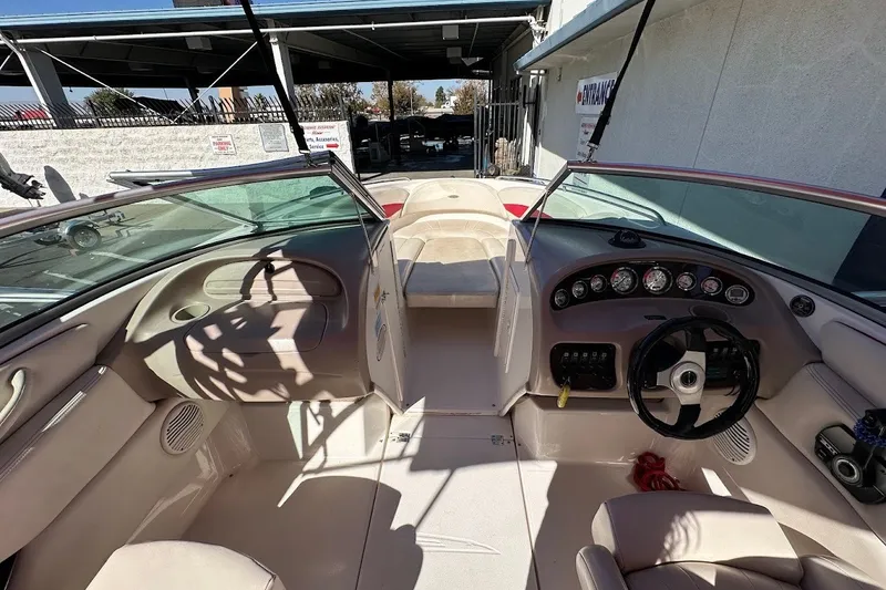 Slide: The Image of Interior view of a 2000 Chaparral 216 SSi boat, showcasing dashboard and seating. - 13