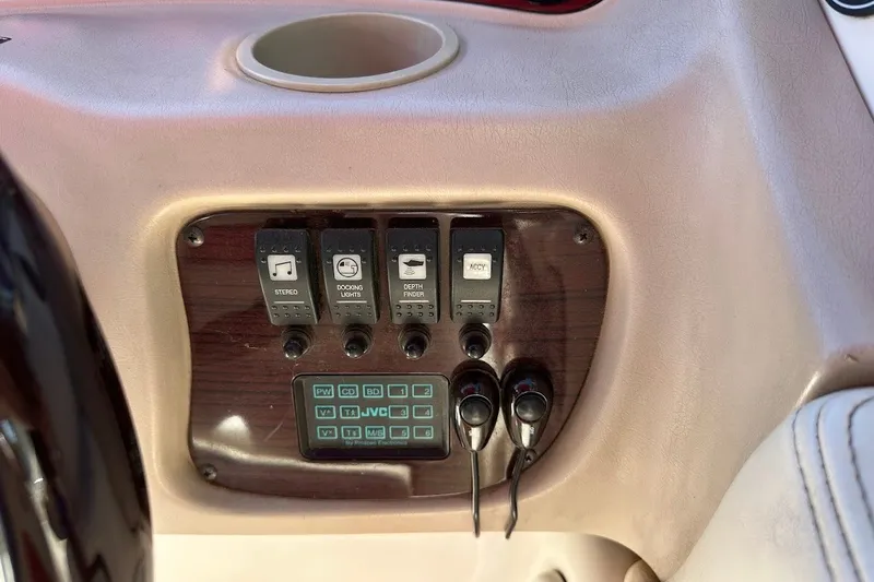 Slide: The Image of Control panel of a 2000 Chaparral 216 SSi boat with switches and cup holder. - 26