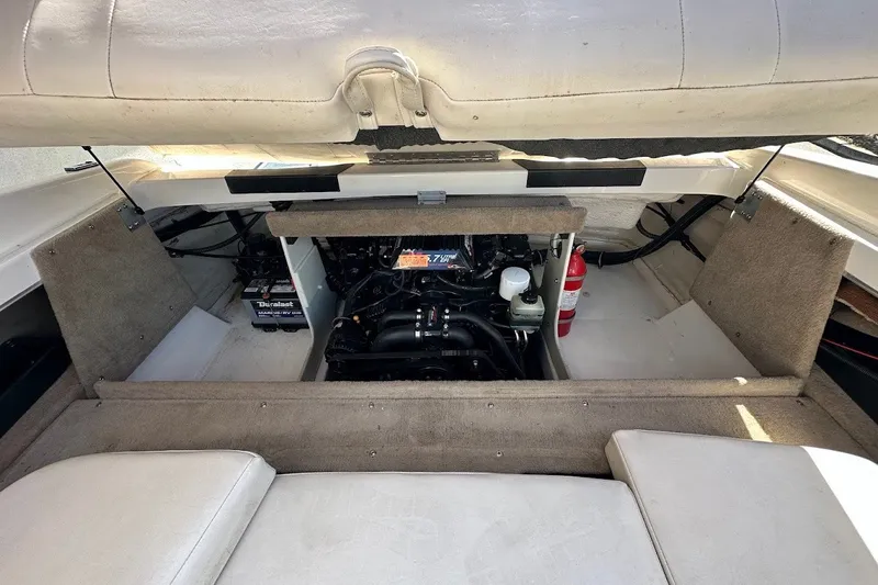 Slide: The Image of Engine compartment of a 2000 Chaparral 216 SSi boat, featuring a visible battery and fire extinguisher. - 30