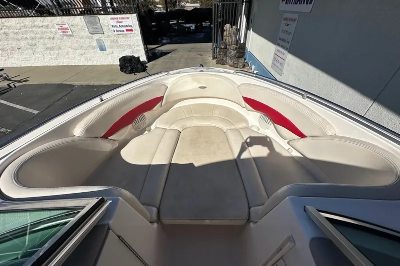 Slide: The Image of 2000 Chaparral 216 SSi boat interior with beige seating and red accents. - 28