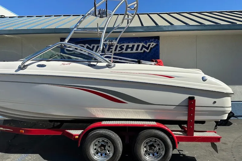 Slide: The Image of 2000 Chaparral 216 SSi boat on red trailer, parked outdoors. - 5