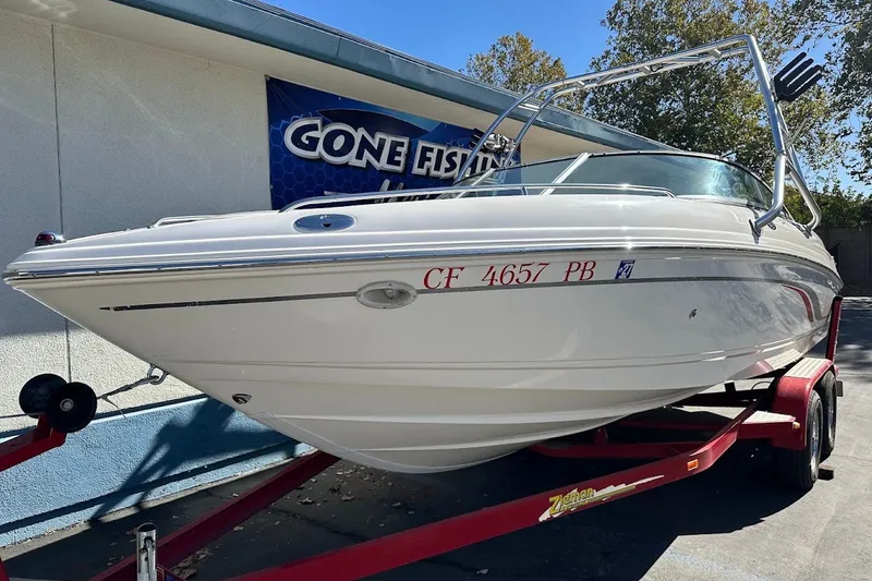 Slide: The Image of 2000 Chaparral 216 SSi boat on red trailer, parked outdoors. - 4