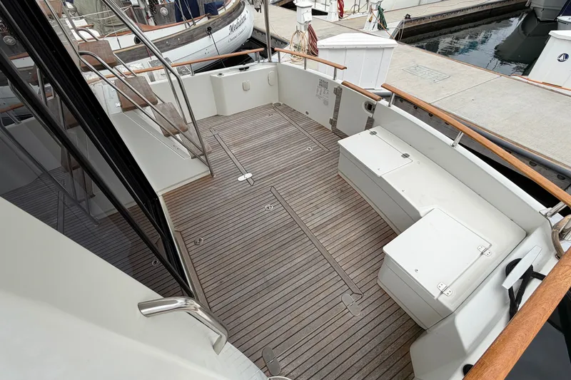 Slide: The Image of Spacious deck of 2019 Beneteau Swift Trawler 44 with wooden flooring and seating. - 8