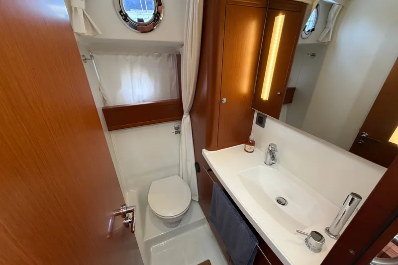 Slide: The Image of Bathroom interior of 2019 Beneteau Swift Trawler 44 with modern fixtures and wooden cabinetry. - 26