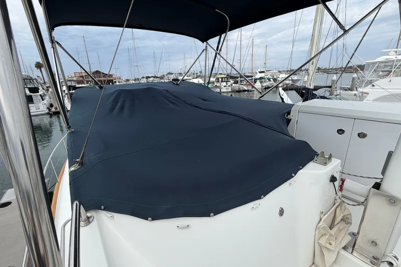 Slide: The Image of 2019 Beneteau Swift Trawler 44 with blue cover docked at marina. - 9