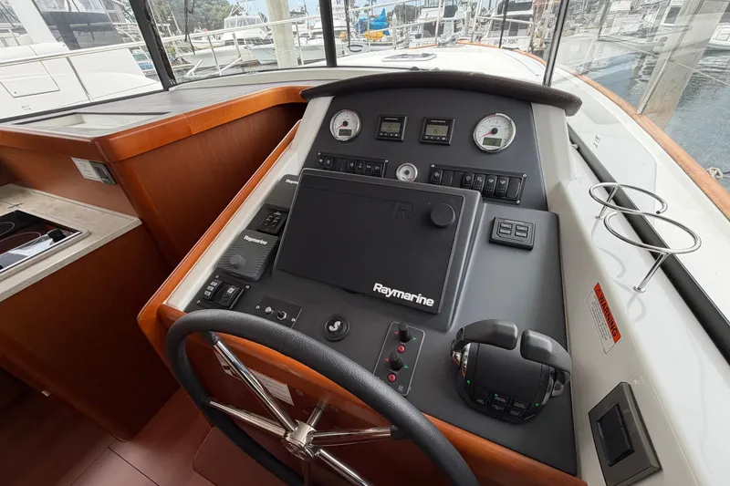 Slide: The Image of Helm station of 2019 Beneteau Swift Trawler 44 with Raymarine navigation system. - 18