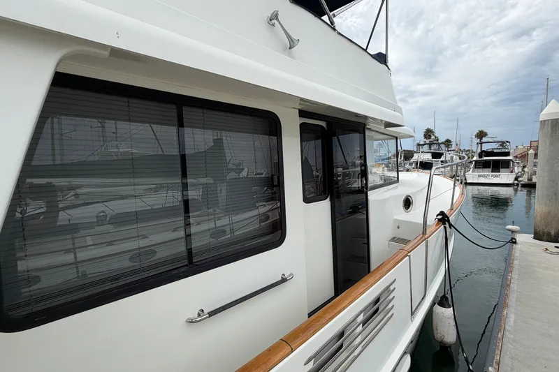 Slide: The Image of 2019 Beneteau Swift Trawler 44 docked at marina, side view. - 7
