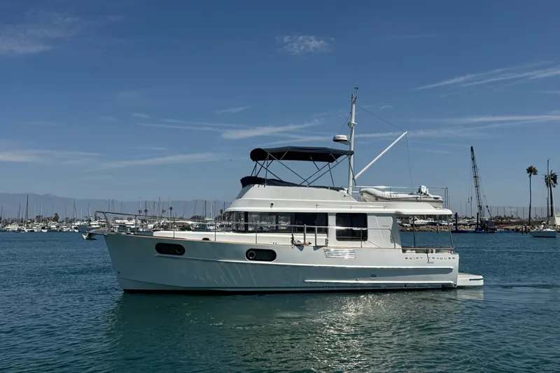 The Image of 2019 Beneteau Swift Trawler 44 yacht on calm water, marina in background. - 0