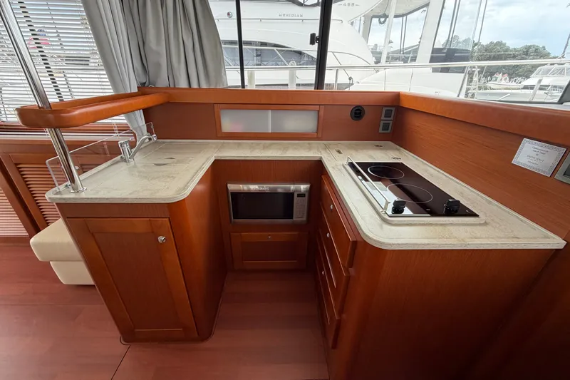 Slide: The Image of Interior view of 2019 Beneteau Swift Trawler 44 kitchen with stove and microwave. - 24