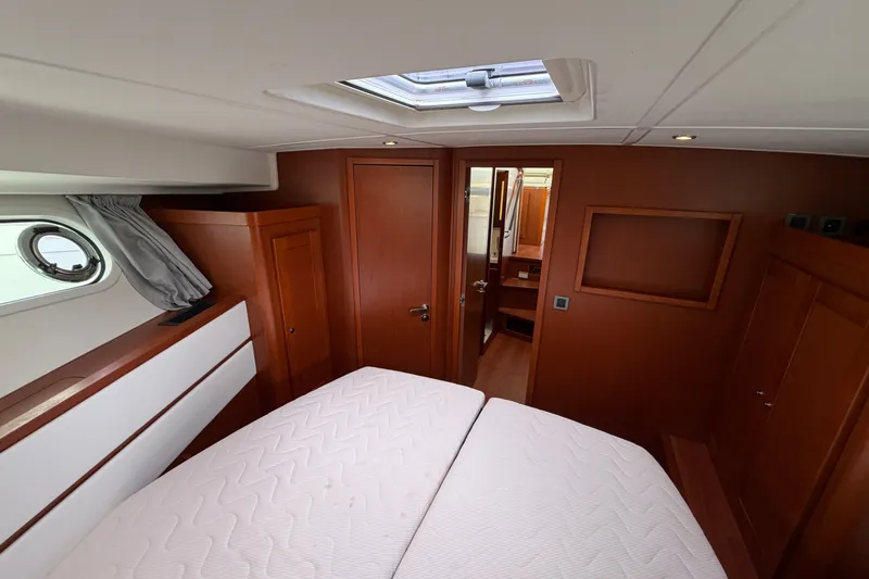 Slide: The Image of Interior cabin of 2019 Beneteau Swift Trawler 44 with wooden finishes and skylight. - 29