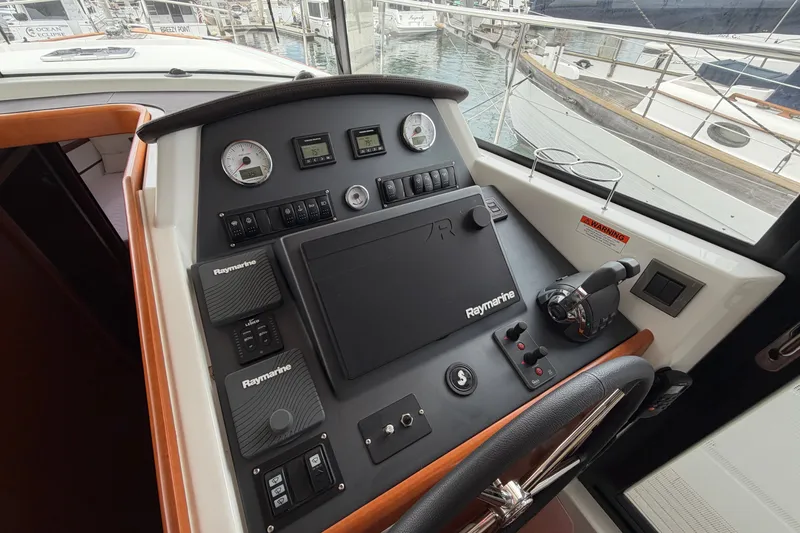 Slide: The Image of Control panel of a 2019 Beneteau Swift Trawler 44 with Raymarine navigation equipment. - 19