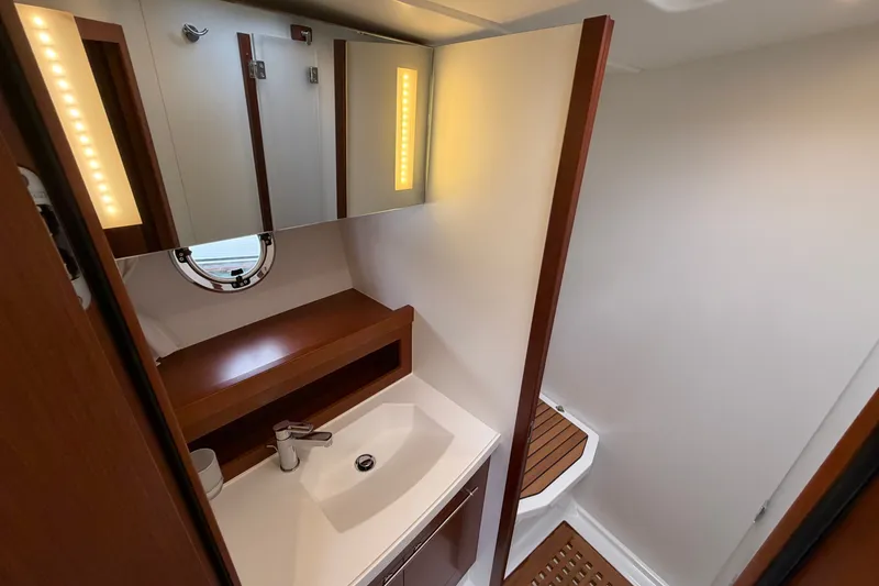 Slide: The Image of Luxurious bathroom in 2019 Beneteau Swift Trawler 44 with modern fixtures and wood accents. - 30