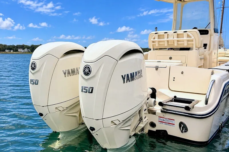 Slide: The Image of Two Yamaha 150 outboard engines on a Grady-White Fisherman 257 boat on calm water. - 3