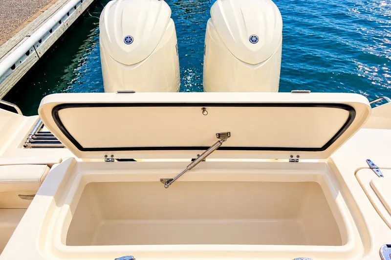 Slide: The Image of 2025 Grady-White Fisherman 257 boat with open storage compartment and twin outboard engines. - 5