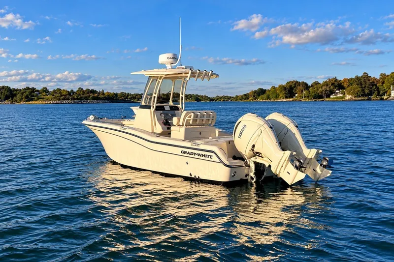 Slide: The Image of 2025 Grady-White Fisherman 257 boat on serene blue water under clear sky. - 1
