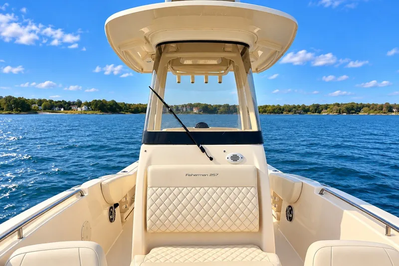 Slide: The Image of 2025 Grady-White Fisherman 257 boat on serene blue water under a clear sky. - 7