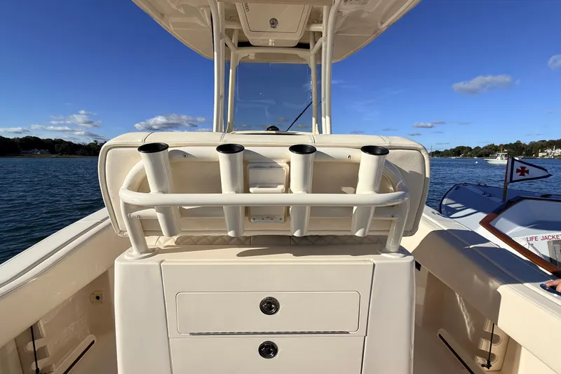 Slide: The Image of 2025 Grady-White Fisherman 257 boat interior with rod holders, on a sunny day. - 10