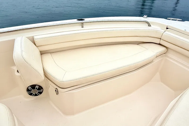 Slide: The Image of 2025 Grady-White Fisherman 257 boat interior with beige seating and speaker detail. - 24
