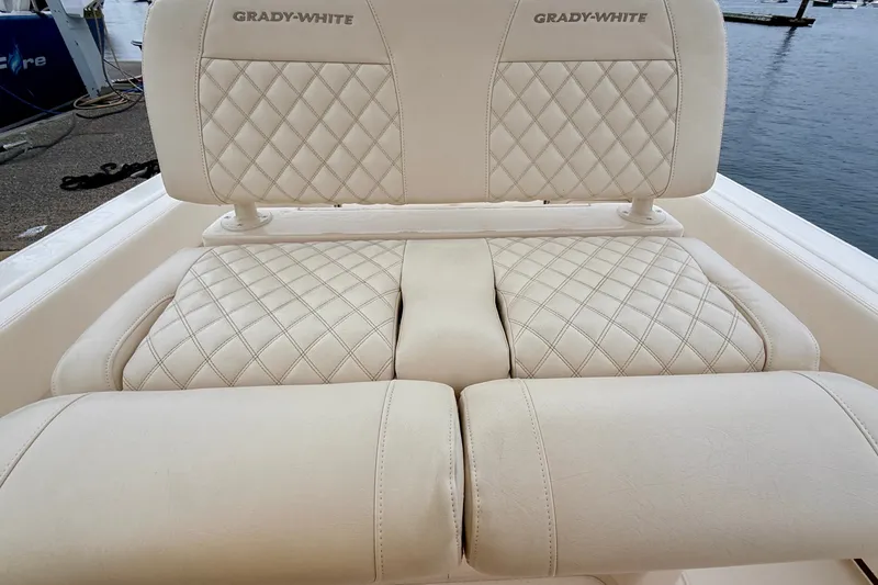 Slide: The Image of Luxurious seating on 2025 Grady-White Fisherman 257 boat, featuring diamond-stitched upholstery. - 19