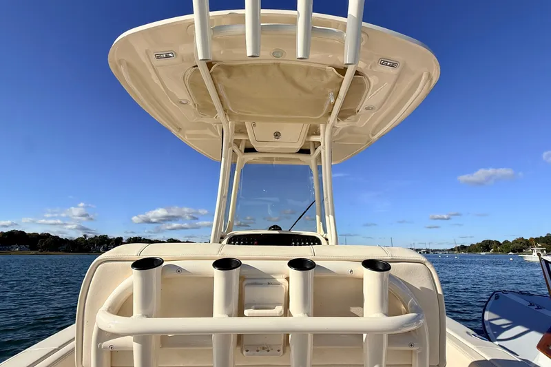 Slide: The Image of 2025 Grady-White Fisherman 257 boat, featuring rod holders and T-top, on a sunny day at sea. - 9
