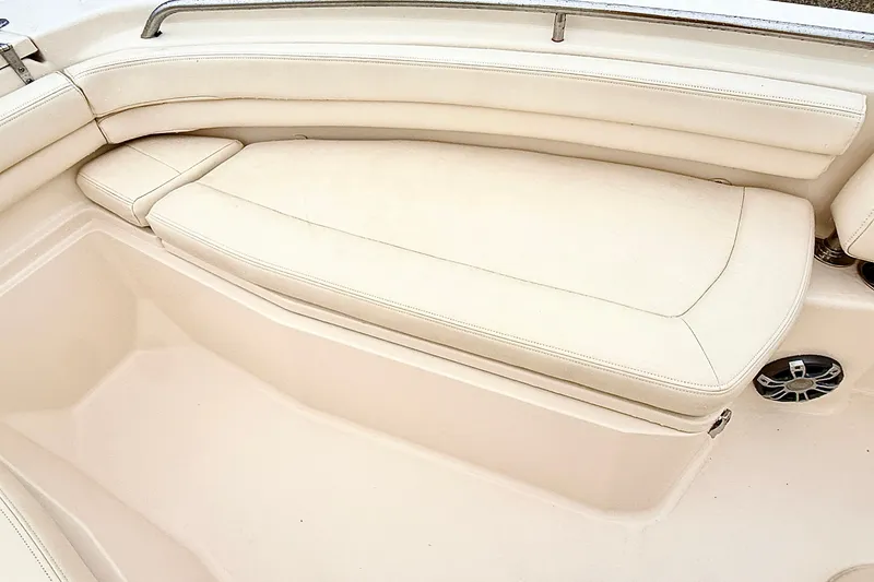 Slide: The Image of 2025 Grady-White Fisherman 257 boat interior with beige cushioned seating. - 22
