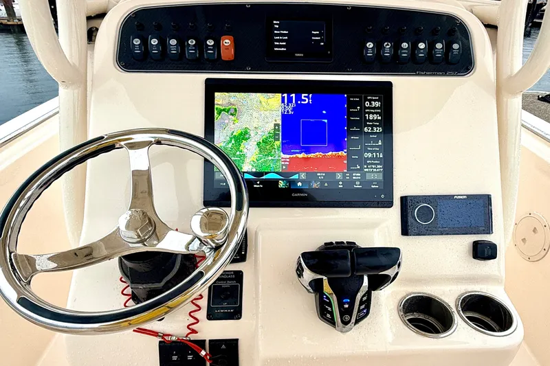 Slide: The Image of 2025 Grady-White Fisherman 257 dashboard with Garmin navigation and control systems. - 11