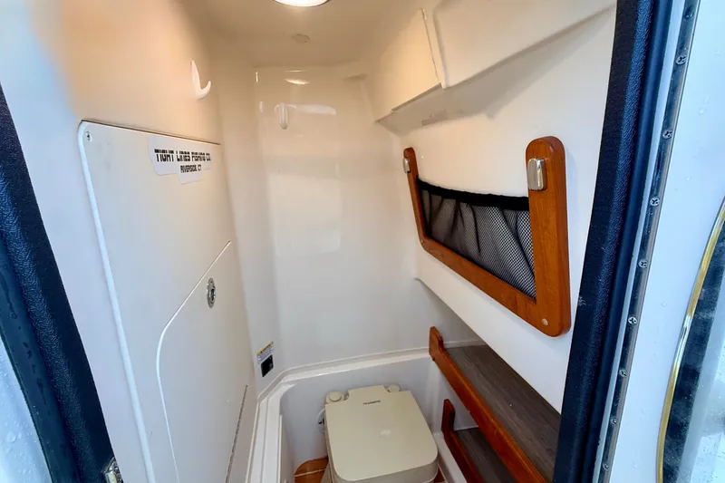 Slide: The Image of 2025 Grady-White Fisherman 257 boat interior with compact toilet and storage. - 21