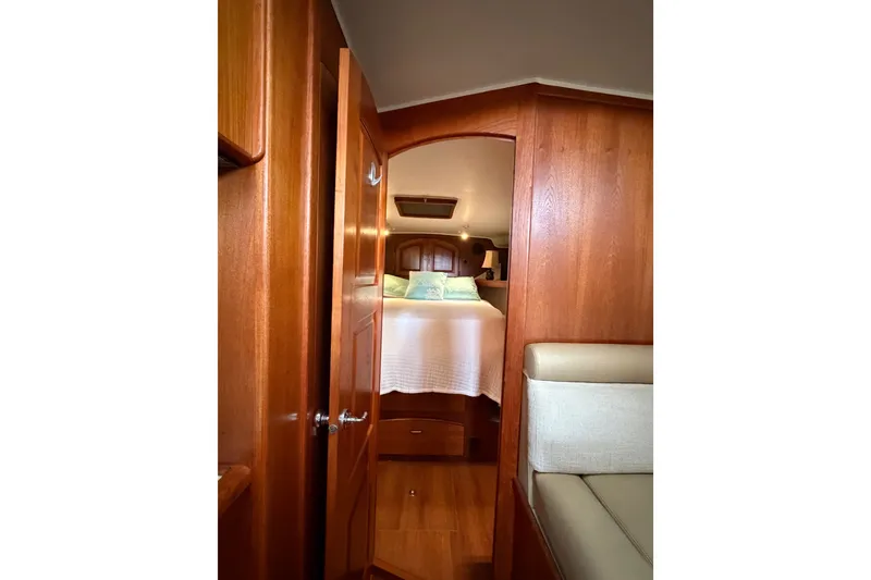 Slide: The Image of 1989 Californian Aft Cabin interior with wooden finish and cozy bed. - 37