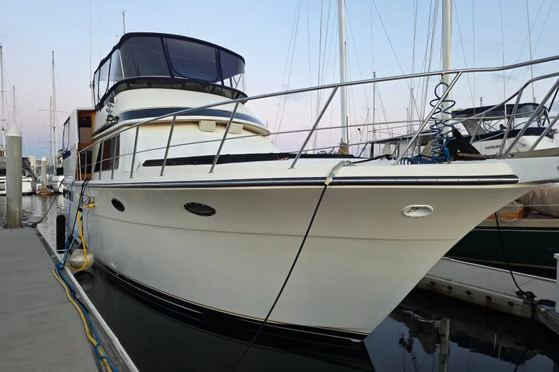 The Image of 1989 Californian Aft Cabin yacht docked at marina, showcasing sleek design and spacious deck. - 0