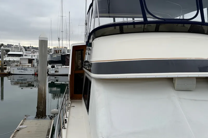 Slide: The Image of 1989 Californian Aft Cabin yacht docked at a marina, surrounded by other boats. - 52