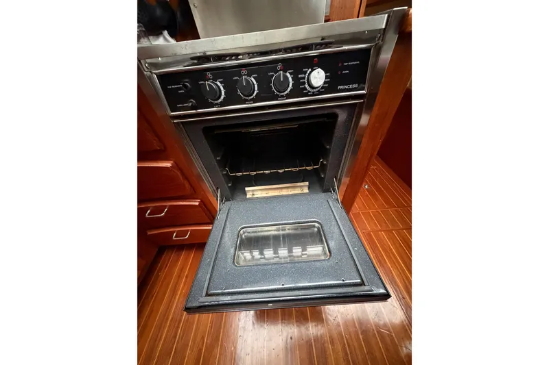 Slide: The Image of 1989 Californian Aft Cabin oven with open door, showcasing controls and interior. - 30