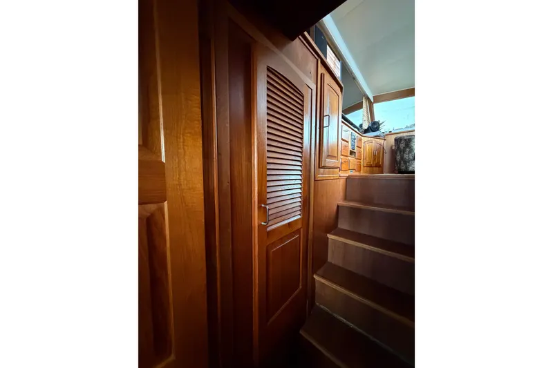 Slide: The Image of Interior of 1989 Californian Aft Cabin yacht with wooden stairs and cabinetry. - 22