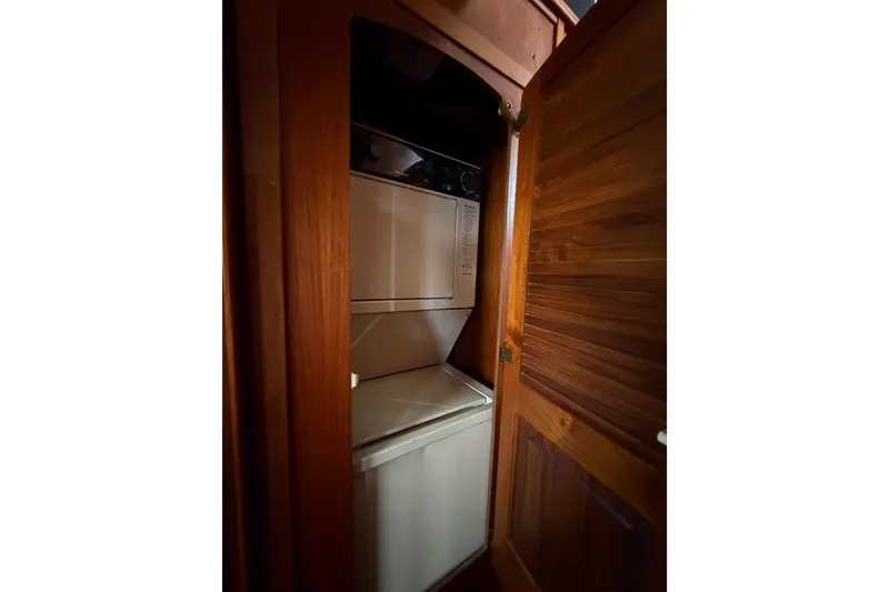 Slide: The Image of 1989 Californian Aft Cabin laundry area with stacked washer and dryer. - 38
