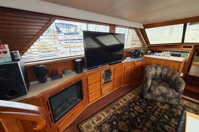 Slide: The Image of Luxurious 1989 Californian Aft Cabin interior with TV, wood cabinetry, and patterned chair. - 21