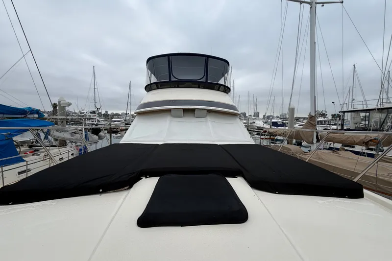 Slide: The Image of 1989 Californian Aft Cabin yacht docked at marina, overcast sky, surrounded by sailboats. - 51